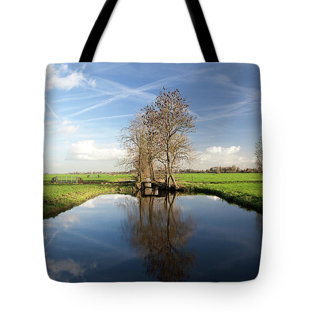 Netherlands Tote Bag featuring the photograph Dutch Polder With Wide Ditch And Trees by Roel Meijer