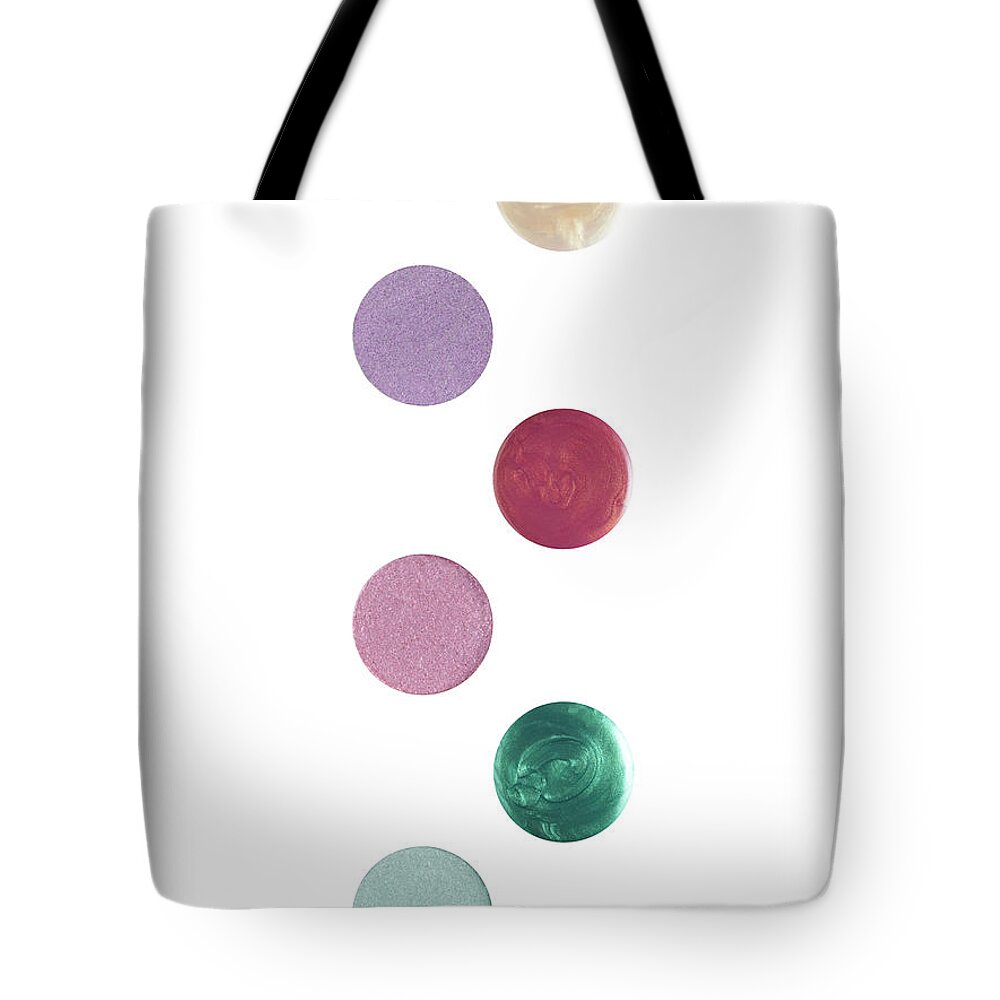 White Background Tote Bag featuring the photograph Eye Shadows And Nail Polishes On White by Level1studio