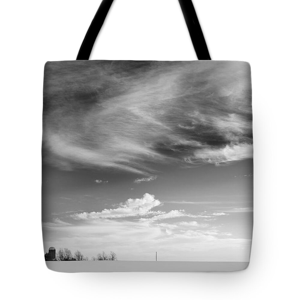 Light Tote Bag featuring the photograph Farm In The Distance In A Snowy Field by Patrick LaRoque