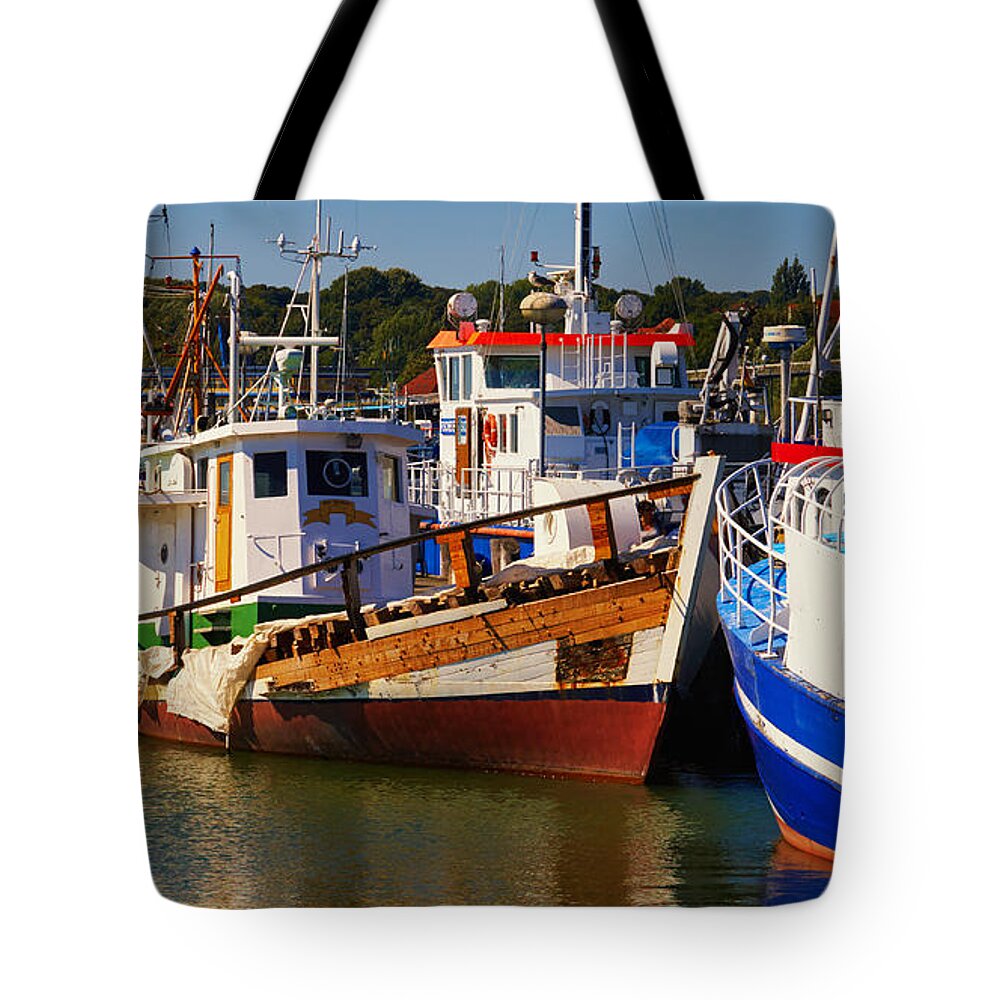 Colorful Tote Bag featuring the photograph Fishing boats in a harbor by Nick Biemans