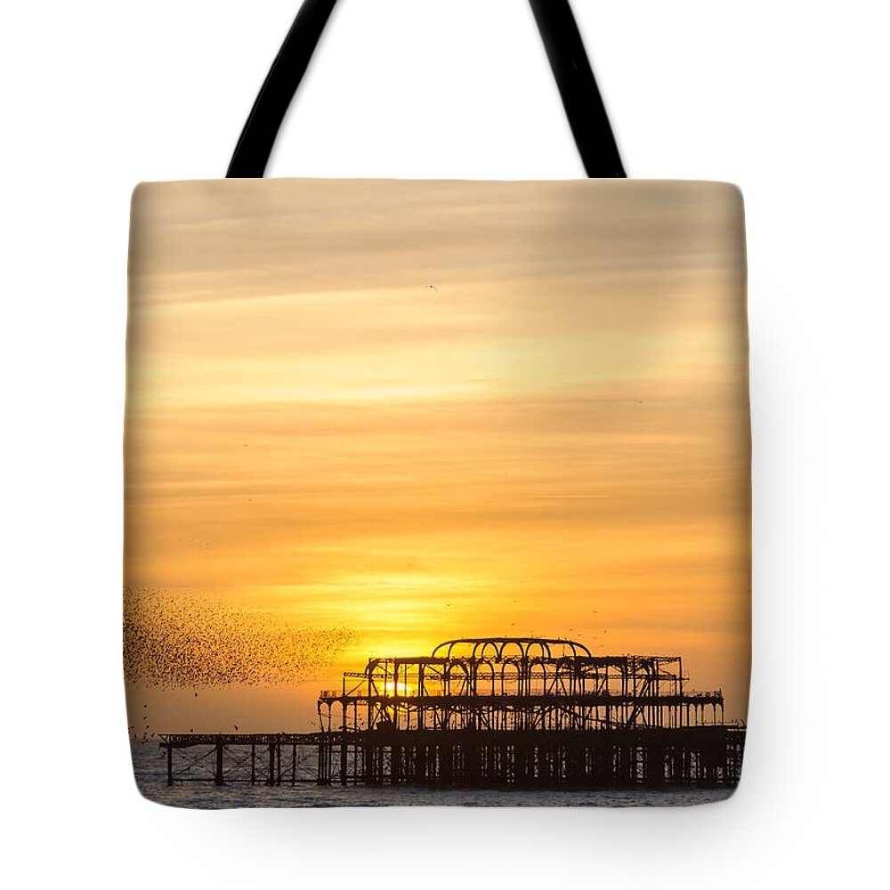 Brighton Tote Bag featuring the photograph Flock of starlings over the west pier in Brighton by Dutourdumonde Photography