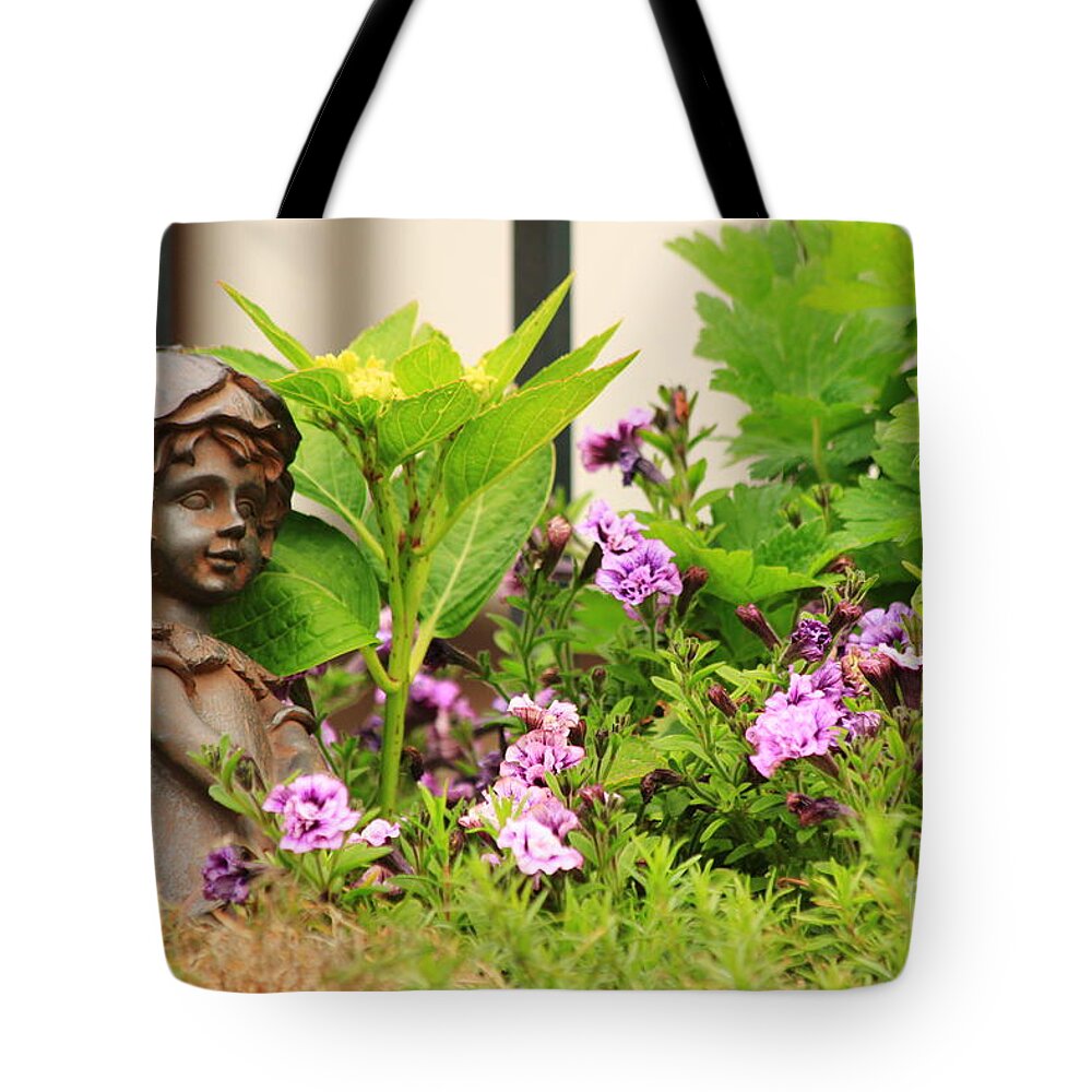 Angel Tote Bag featuring the photograph Flower-bed mit an angel statue by Amanda Mohler