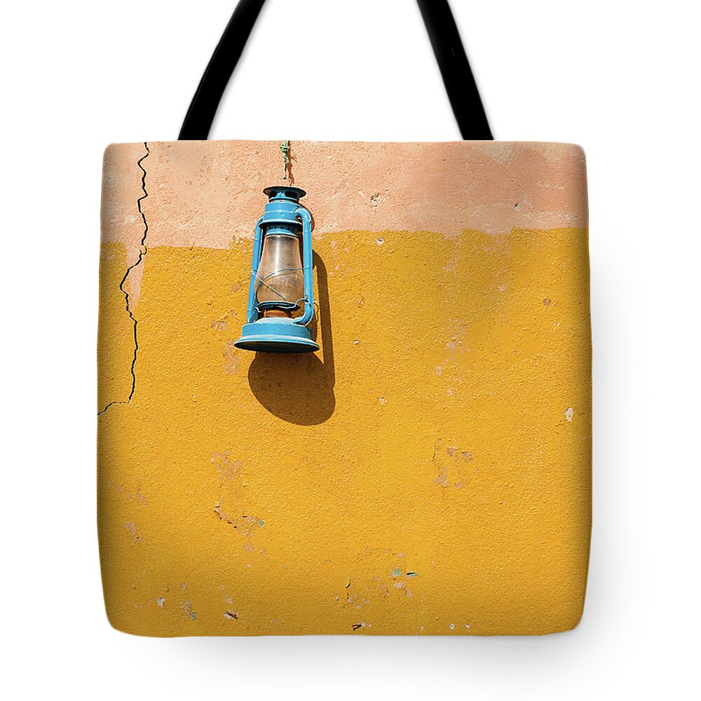 Hanging Tote Bag featuring the photograph Front View Of A Blue Gas Lamp Hanging by Mohamed El Hebeishy