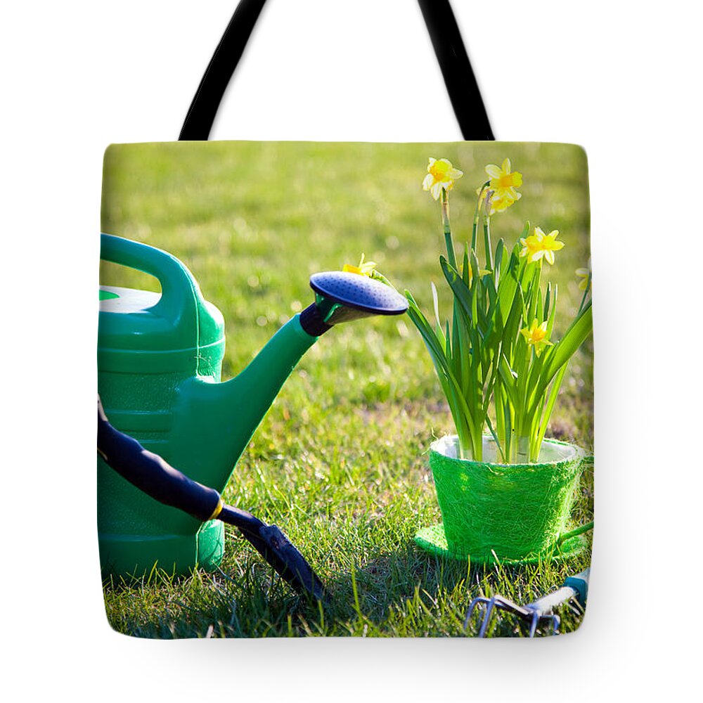 Garden Tote Bag featuring the photograph Gardening tools and flowers by Michal Bednarek