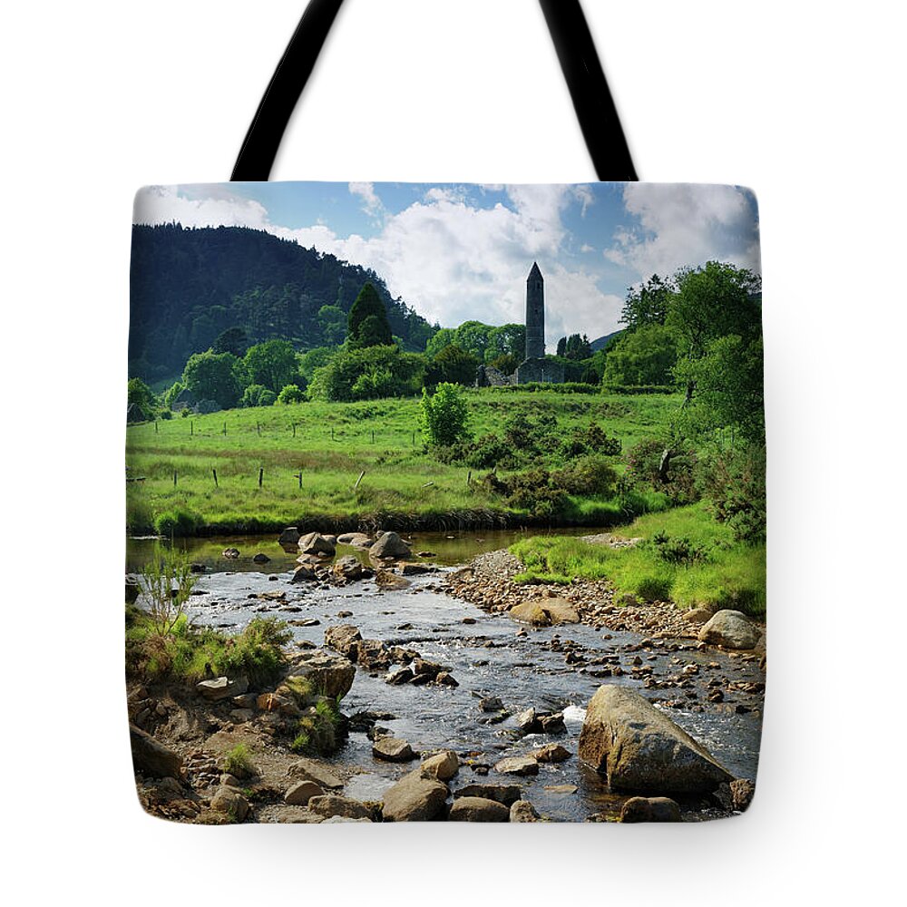 Scenics Tote Bag featuring the photograph Glendalough Creek With The Old Monastic by Mammuth
