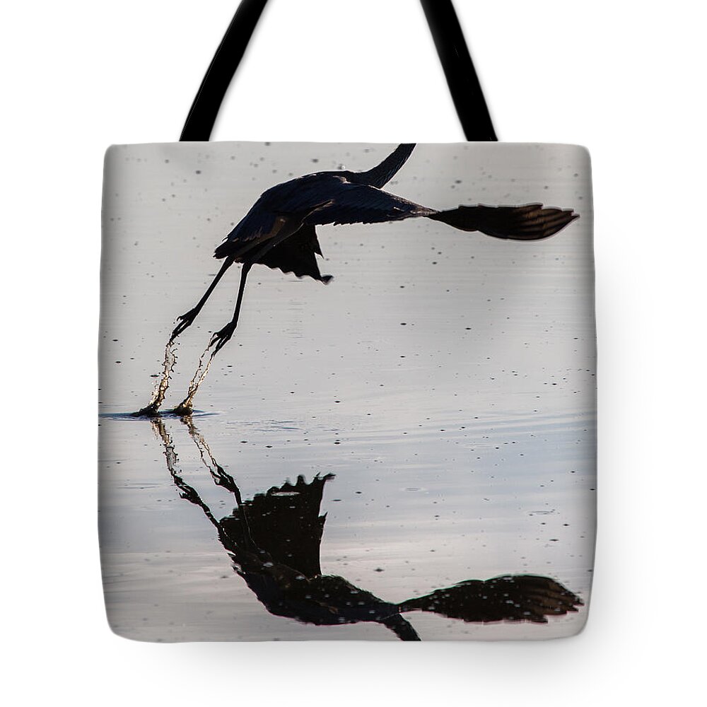 Great Blue Heron Tote Bag featuring the photograph Great Blue Heron Takeoff by John Daly
