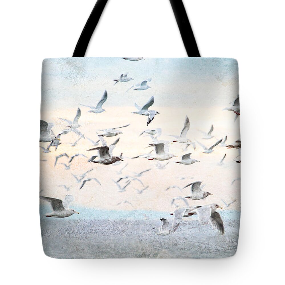 Gulls Tote Bag featuring the photograph Gulls Flying Over the Ocean by Peggy Collins