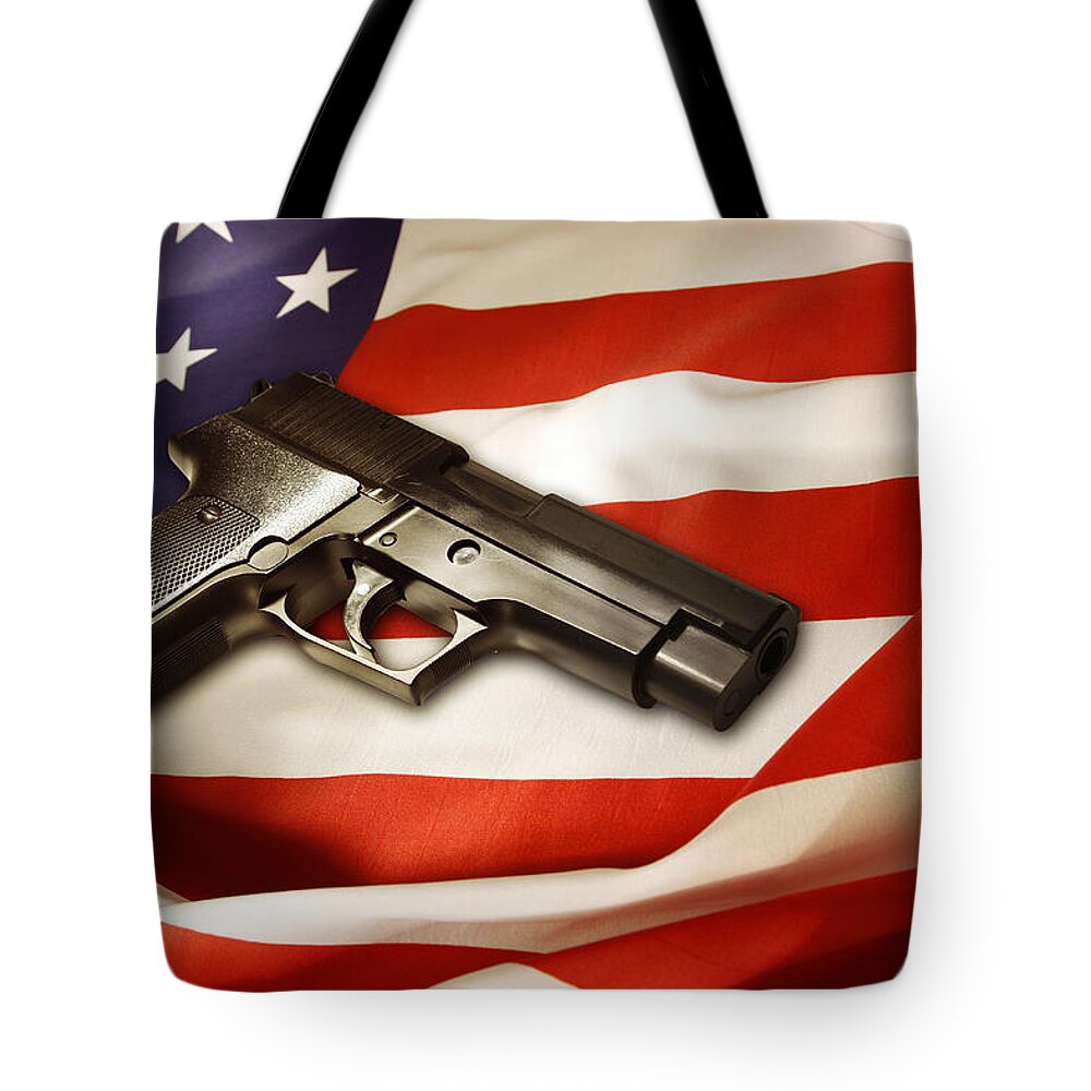 Gun Tote Bag featuring the photograph Gun on flag by Les Cunliffe