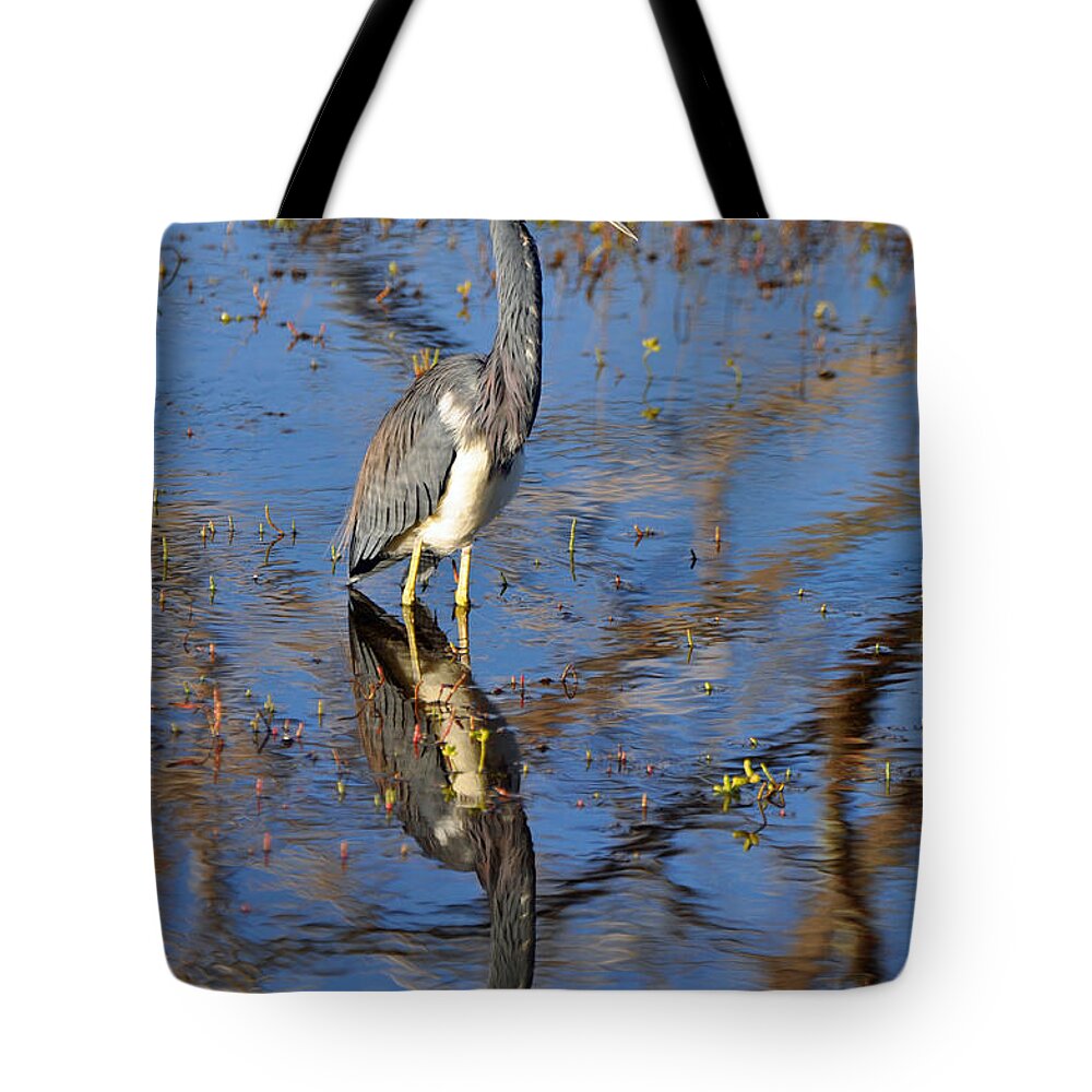 Beach Tote Bag featuring the photograph Heron and Reflection in Jekyll Island's Marsh by Bruce Gourley
