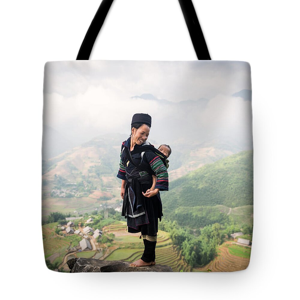 Looking Over Shoulder Tote Bag featuring the photograph Hill Tribe Woman Carrying Baby On Her by Martin Puddy