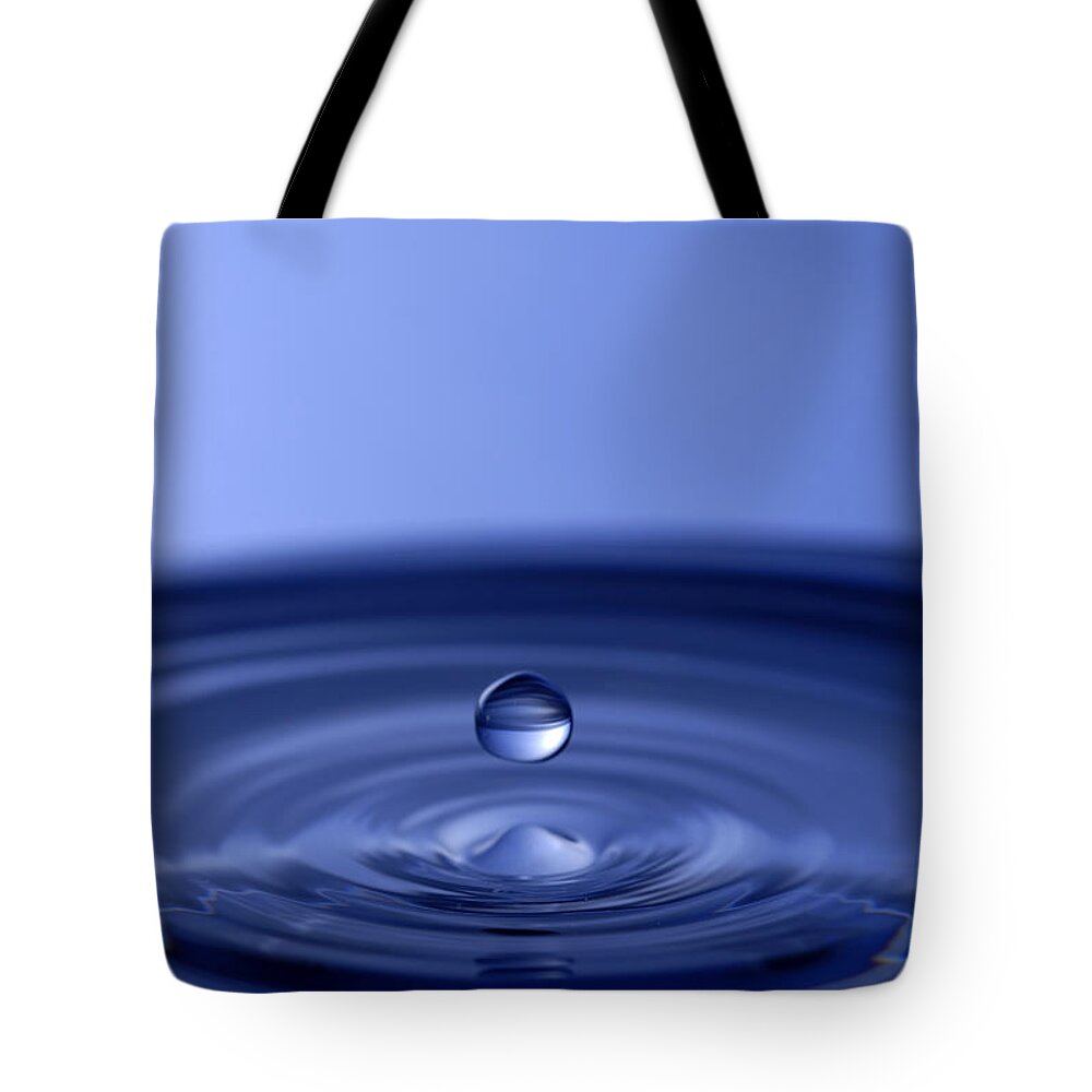 Water Drop Tote Bag featuring the photograph Hovering Blue Water Drop by Anthony Sacco