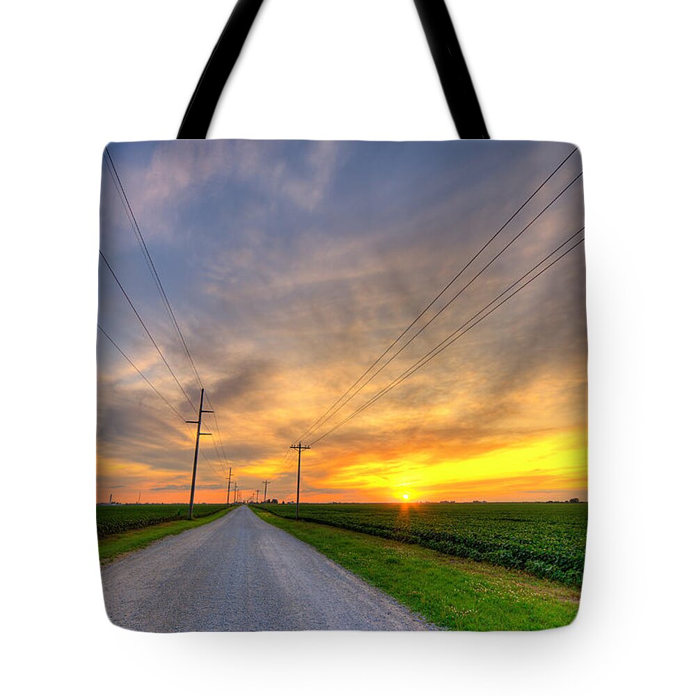 Road Tote Bag featuring the photograph Indiana sunset by Alexey Stiop