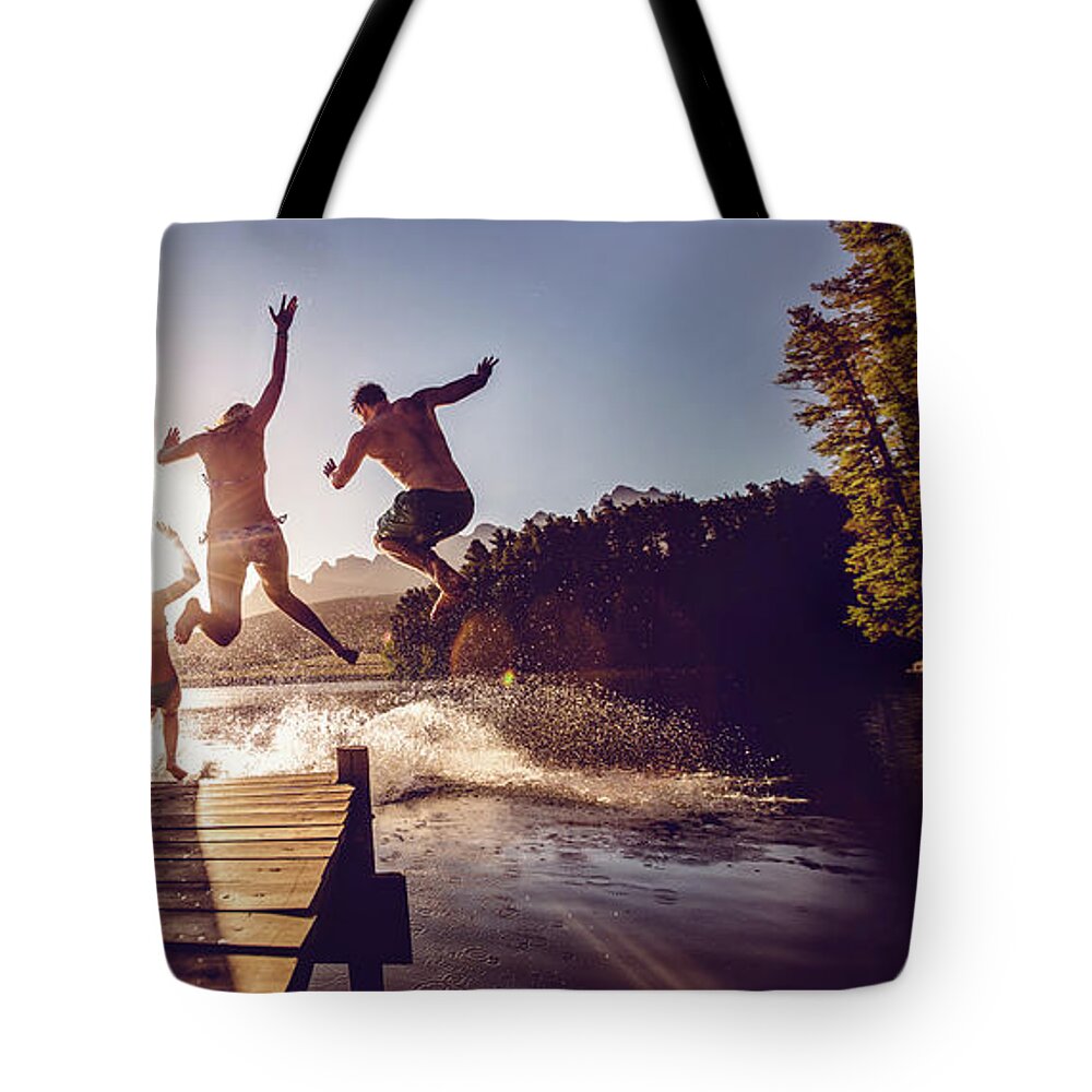 Child Tote Bag featuring the photograph Jumping Into The Water From A Jetty by Wundervisuals