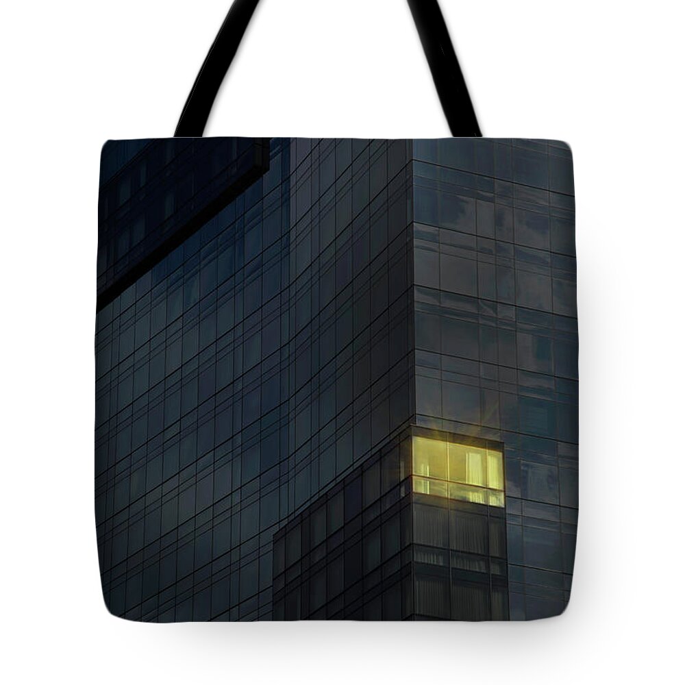 Office Tote Bag featuring the photograph Lit Office In A Dark Building by Buena Vista Images