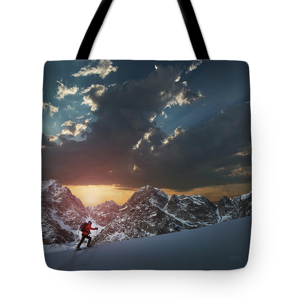 Scenics Tote Bag featuring the photograph Lone Climber On A Snowy Slope At Sunrise by Buena Vista Images