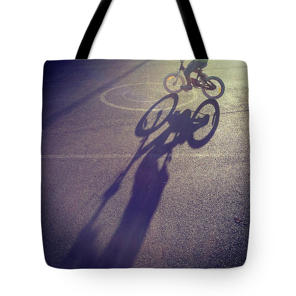 Shadow Tote Bag featuring the photograph Long Shadow Of Child Riding A Bicycle by Jodie Griggs