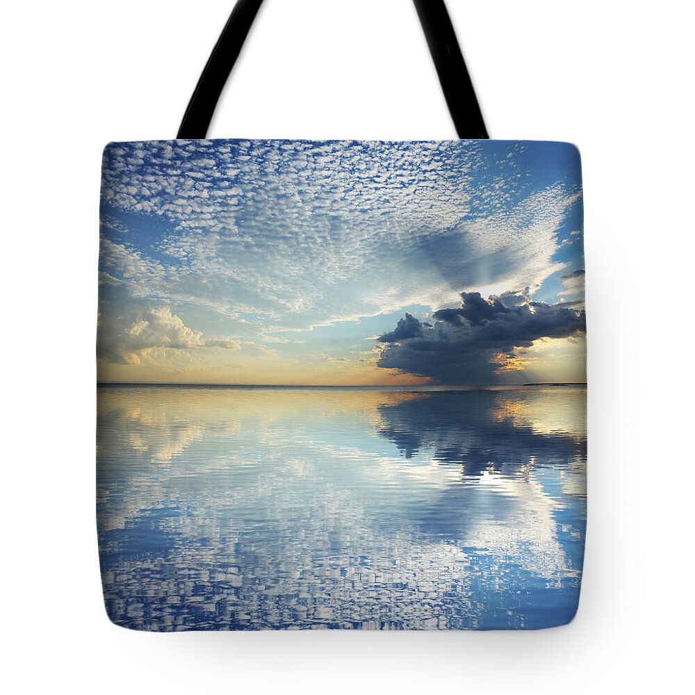 Water's Edge Tote Bag featuring the photograph Magnificient Cloudscape With Water by Buzbuzzer