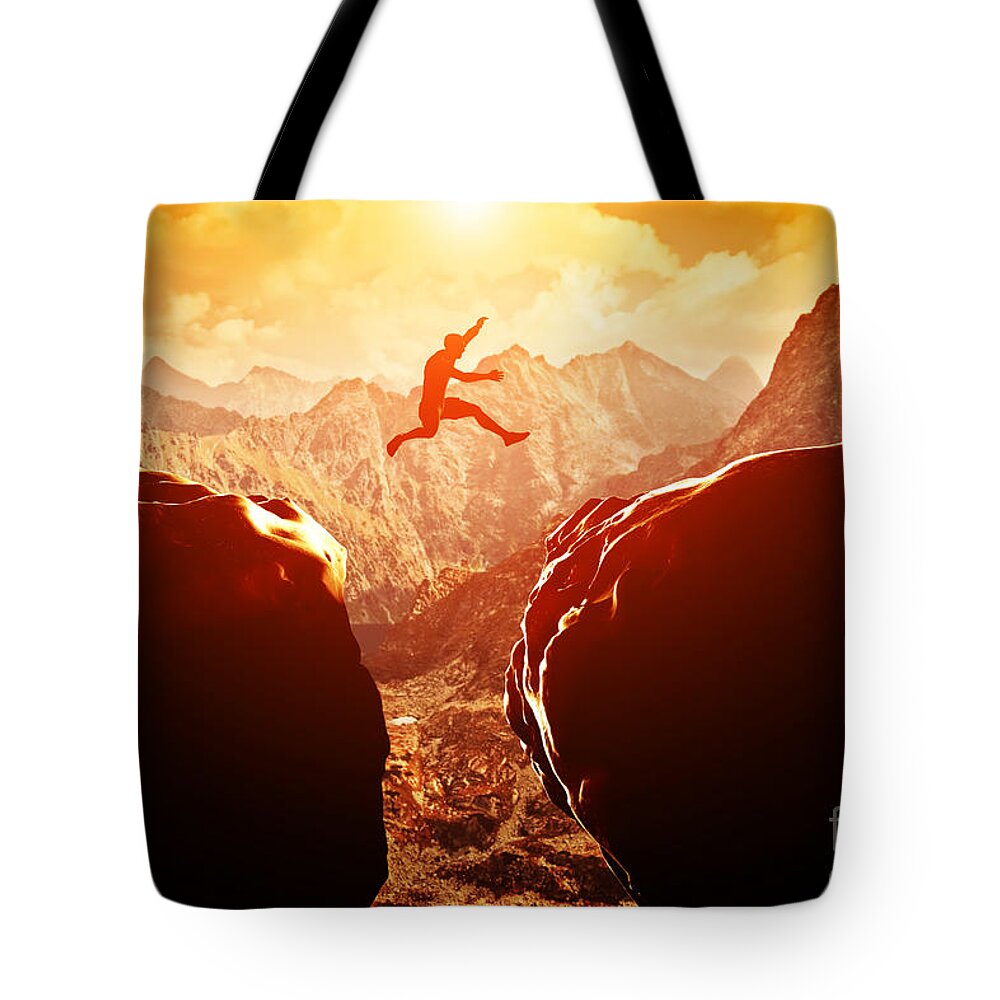 Jump Tote Bag featuring the photograph Man jumping over precipice in mountains by Michal Bednarek