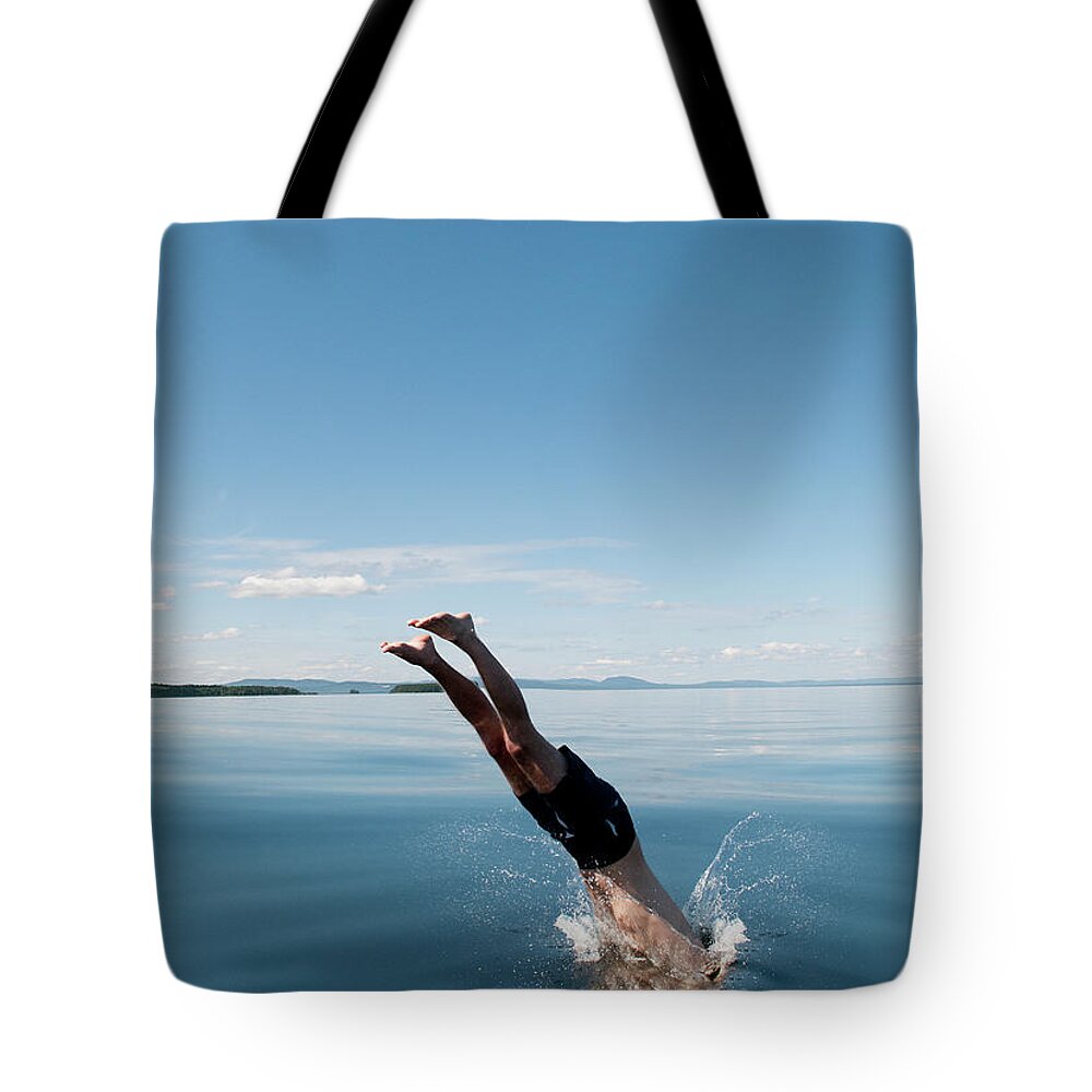 Scenics Tote Bag featuring the photograph Mature Man Jumping In Sea by Johner Images