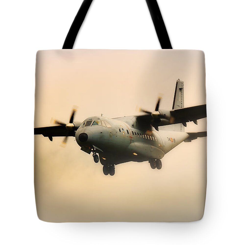 Military Tote Bag featuring the photograph Military transport aircraft coming out of the mist by Nick Biemans