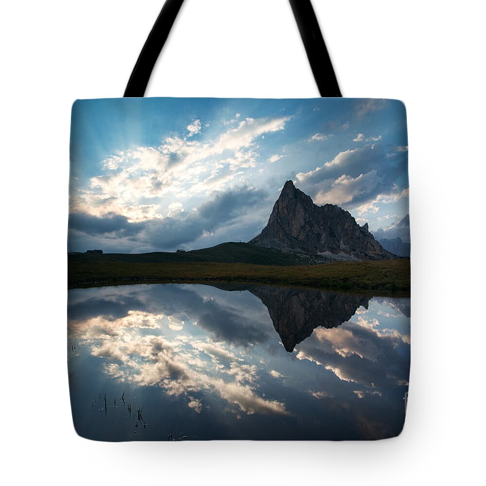 Dolomites Tote Bag featuring the photograph Mountain peak and clouds reflected in alpine lake in the Dolomit by Matteo Colombo