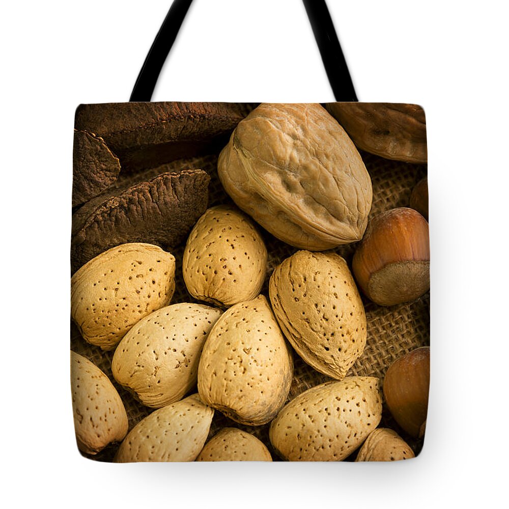 Nuts Tote Bag featuring the photograph Nuts Aglow by Mark McKinney
