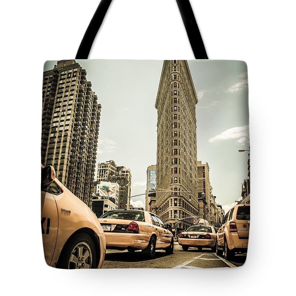Nyc Tote Bag featuring the photograph NYC Yellow cabs at the flat iron building - V1 by Hannes Cmarits