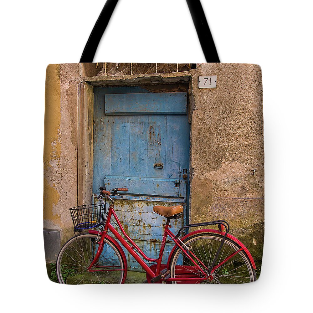 Weathered Tote Bag featuring the photograph Old Red Bicycle Leaning Against A by Carl Larson Photography