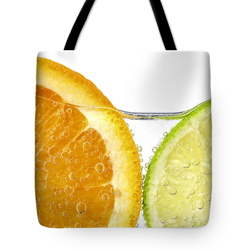 Orange Tote Bag featuring the photograph Orange and lime slices in water by Elena Elisseeva