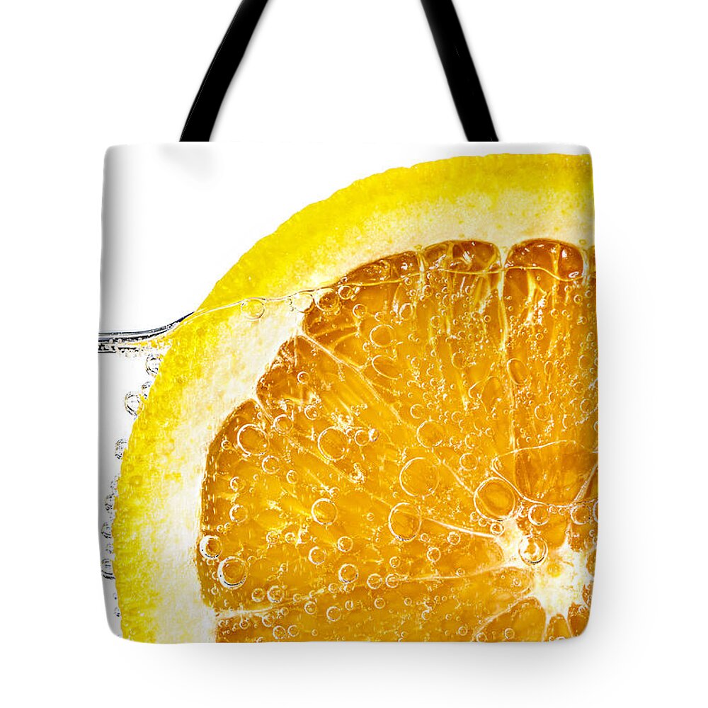 Orange Tote Bag featuring the photograph Orange slice in water by Elena Elisseeva