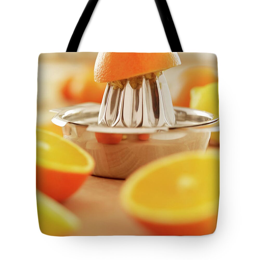 Orange Tote Bag featuring the photograph Oranges And Juicer by Adam Gault