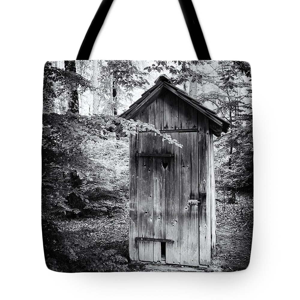 Outhouse Tote Bag featuring the photograph Outhouse in the forest black and white by Matthias Hauser