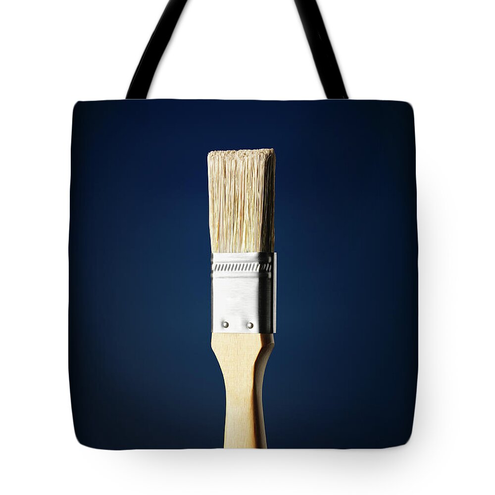 Netherlands Tote Bag featuring the photograph Paintbrush Against A Blue Background by Stuart Minzey