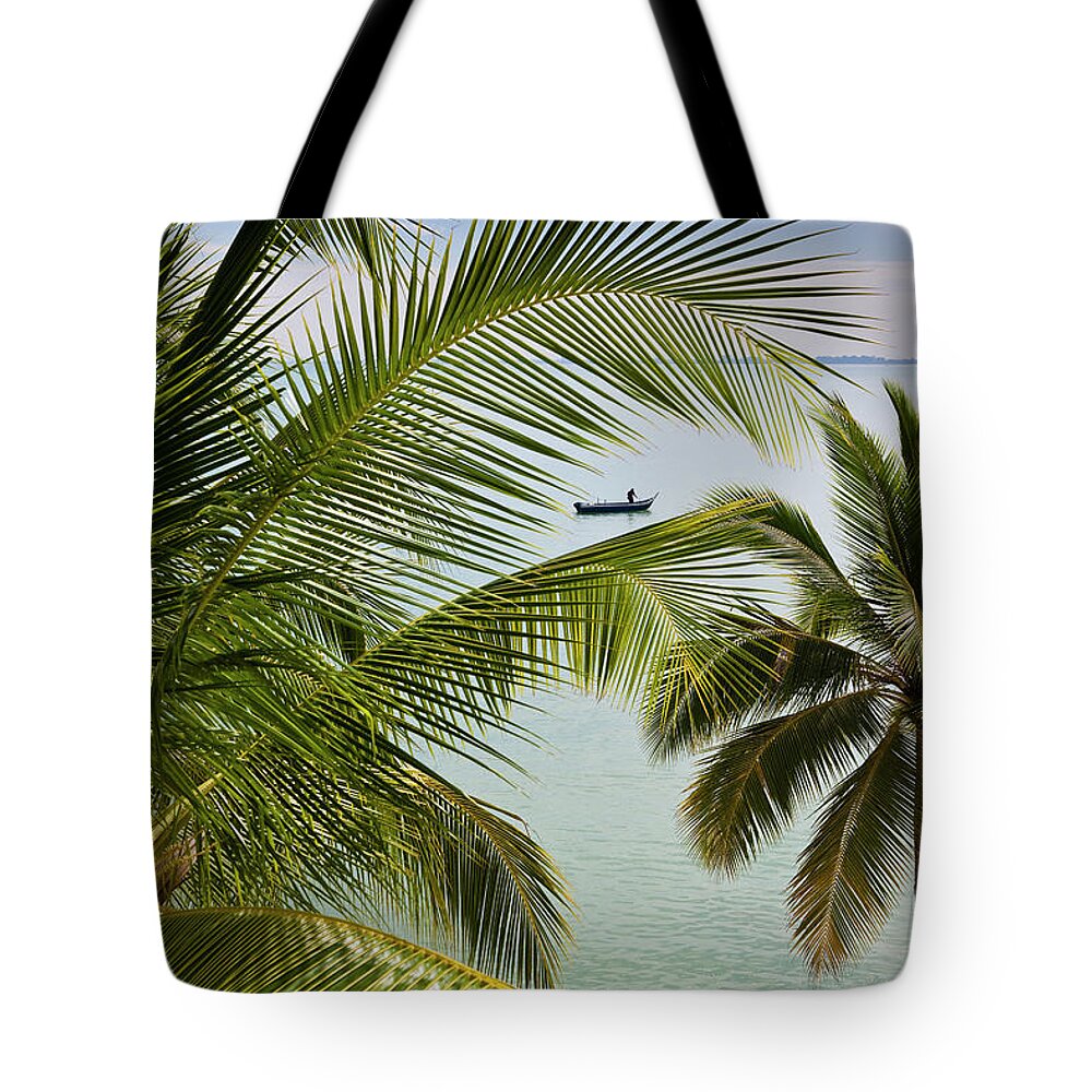 Southeast Asia Tote Bag featuring the photograph Palm Trees And Fisherman In Boat On by Richard I'anson