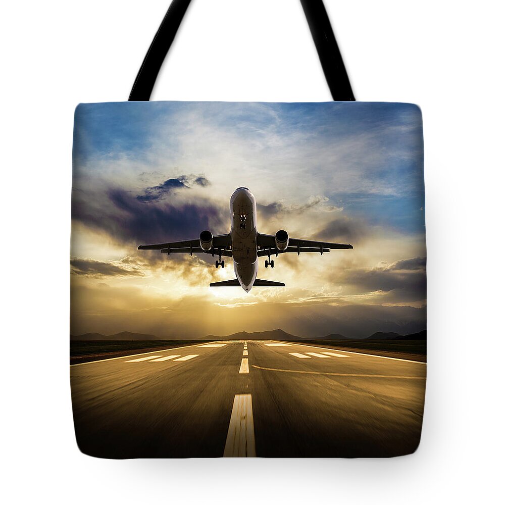 Taking Off Tote Bag featuring the photograph Passenger Airplane Taking Off At Sunset by Guvendemir