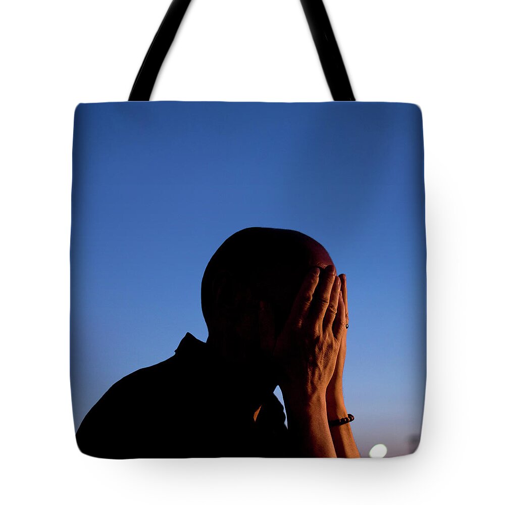 Mature Adult Tote Bag featuring the photograph Portrait Of Man Covering Face With by Maciej Toporowicz, Nyc