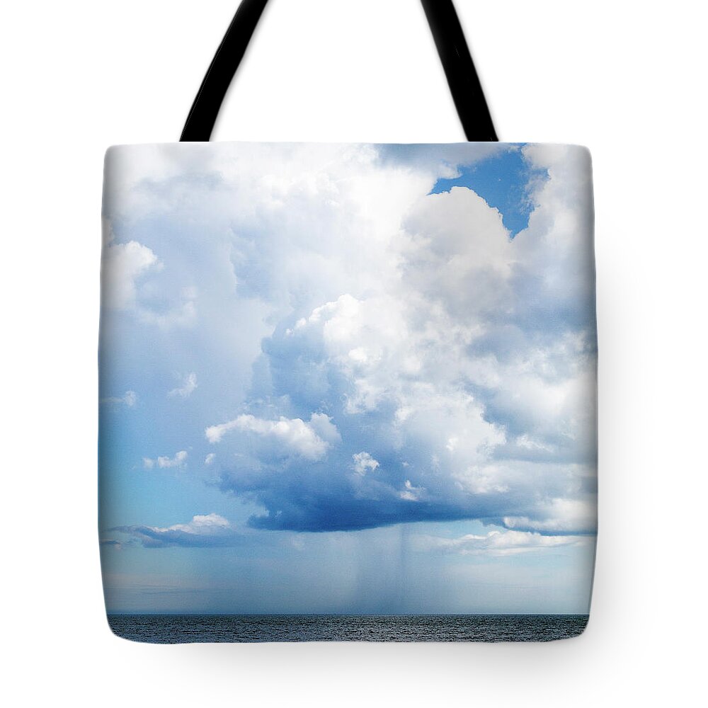 Tranquility Tote Bag featuring the photograph Puffy Cloud Emitting Rain by Maciej Frolow
