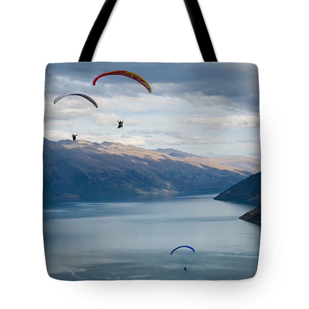 New Zealand Tote Bag featuring the photograph Queenstown Paragliders by Chris Cousins
