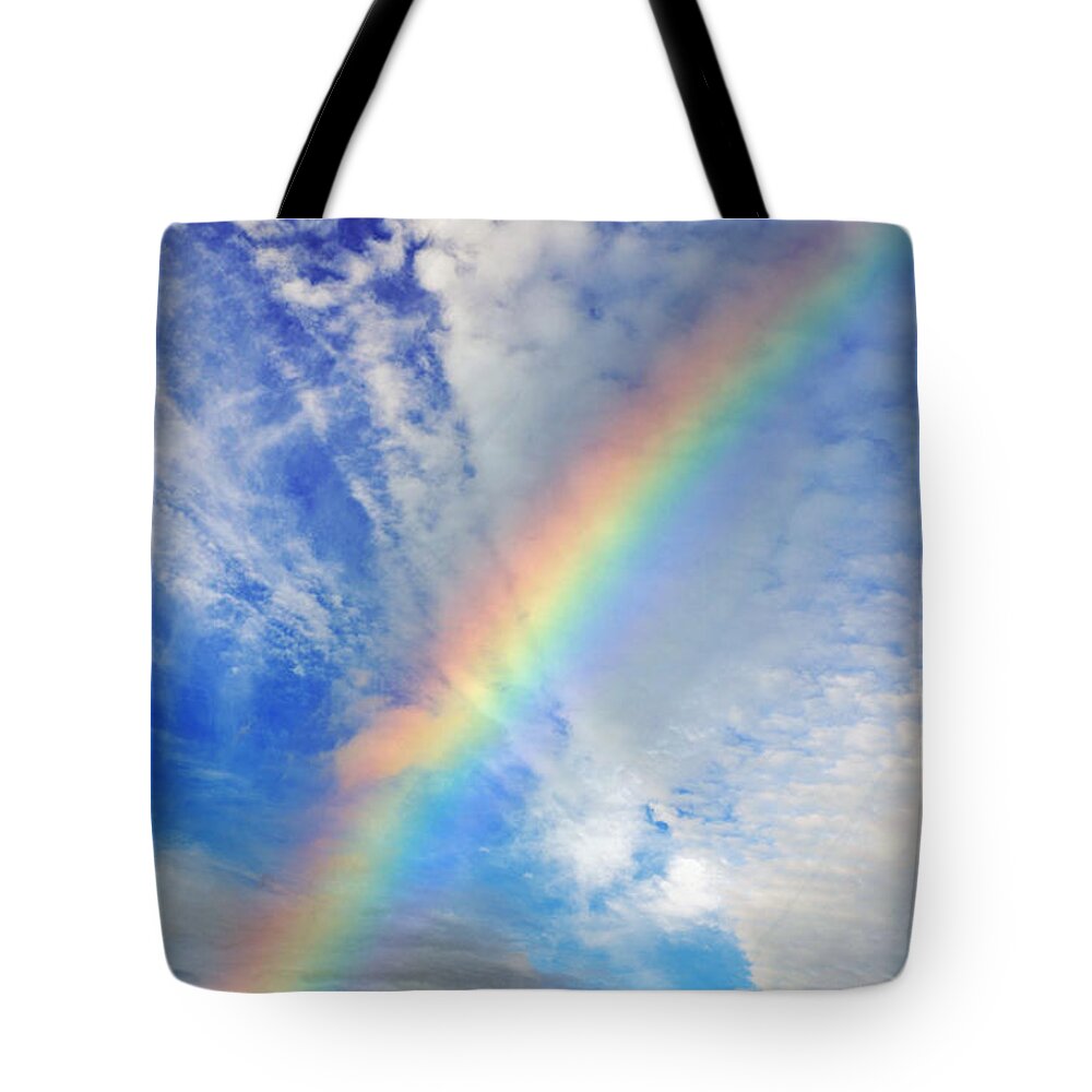 Ca Tote Bag featuring the photograph Rainbow in a Cloud Filled Sky by Jim Fitzpatrick