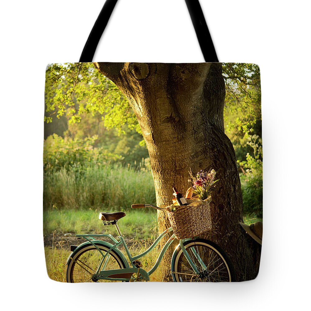 Grass Tote Bag featuring the photograph Retro Bicycle With Red Wine In Picnic by Nightanddayimages
