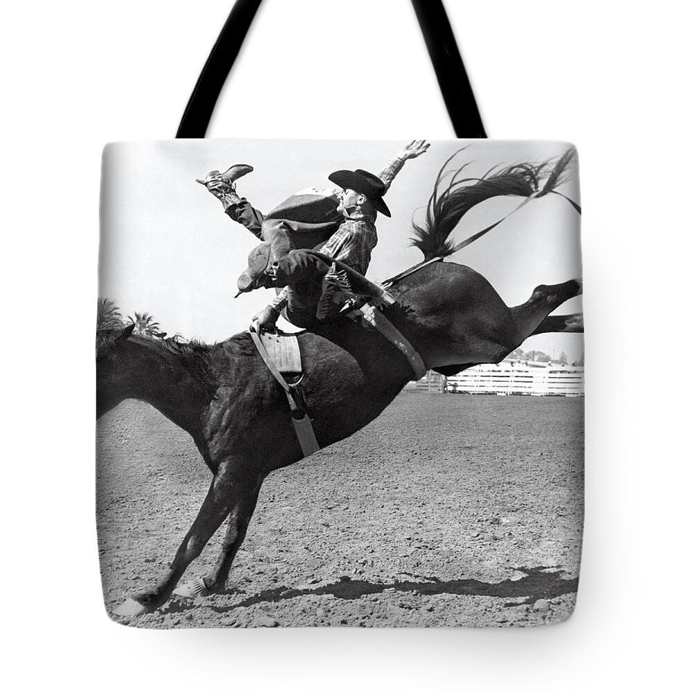 1950 Tote Bag featuring the photograph Riding A Bucking Bronco by Underwood Archives