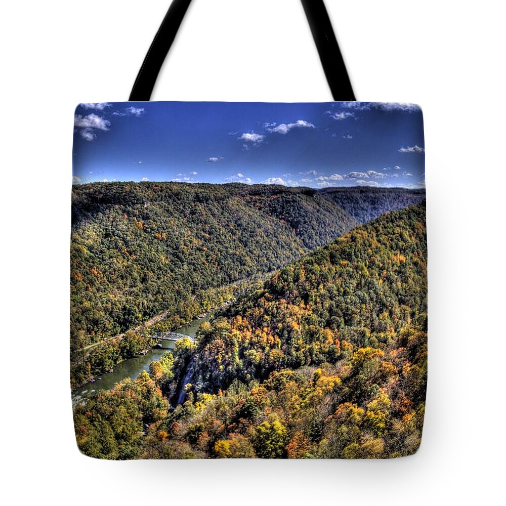 River Tote Bag featuring the photograph River running through a valley by Jonny D