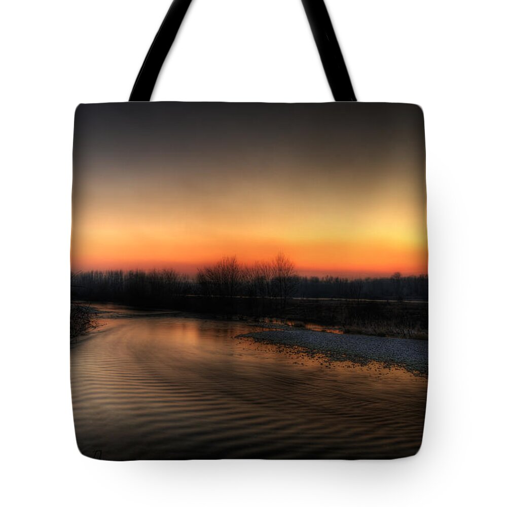 Details Enhancer Tote Bag featuring the photograph Riverscape at sunset by Roberto Pagani