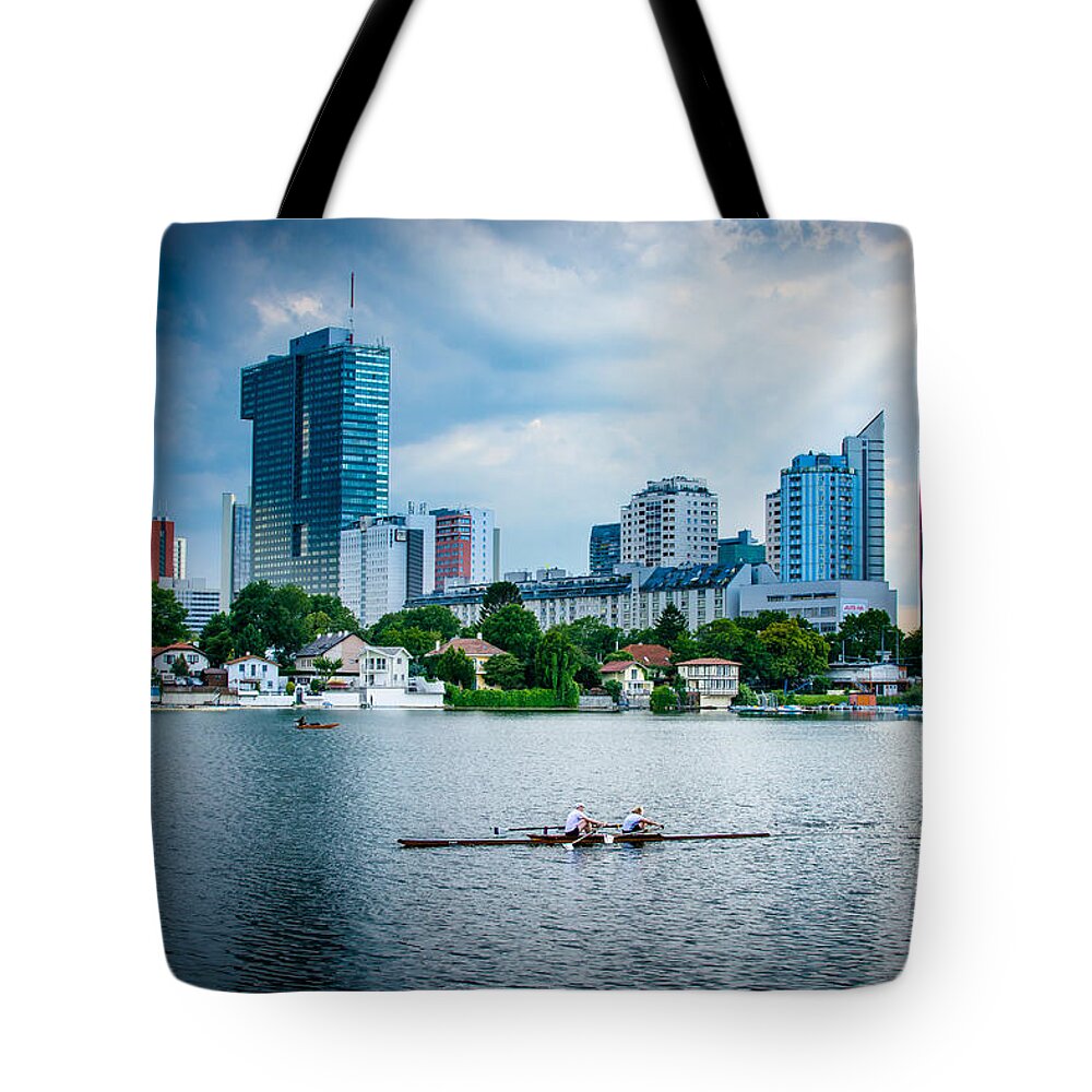 Skyline Tote Bag featuring the photograph Rowing Boat And The Skyline Of Vienna by Andreas Berthold