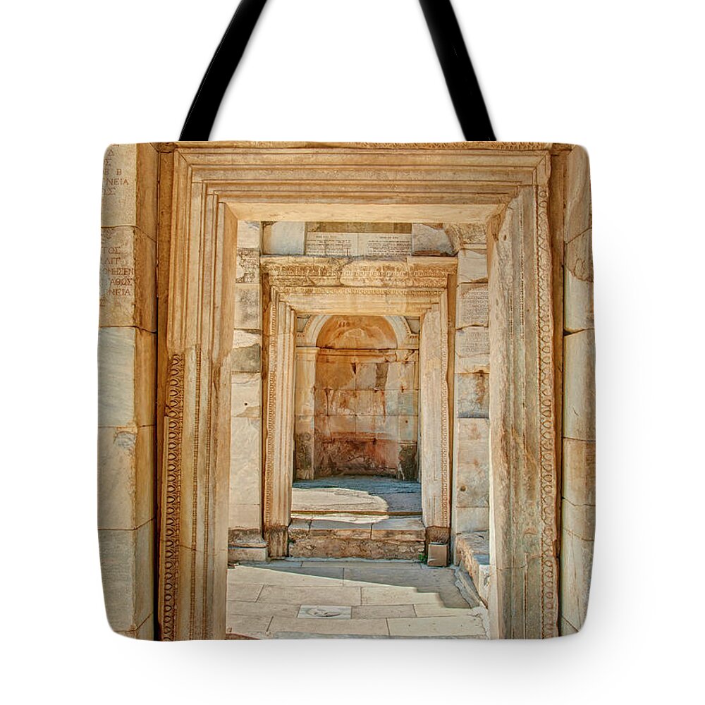 Arch Tote Bag featuring the photograph Ruins Or Ancient Stone Corridor With by Aygulsarvarova