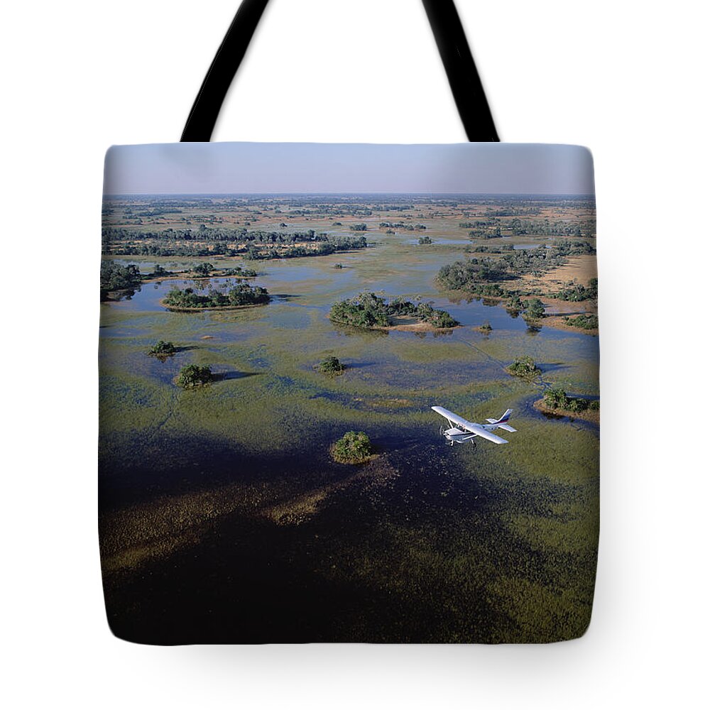 Feb0514 Tote Bag featuring the photograph Safari Airplane Flying Over Okavango by Konrad Wothe