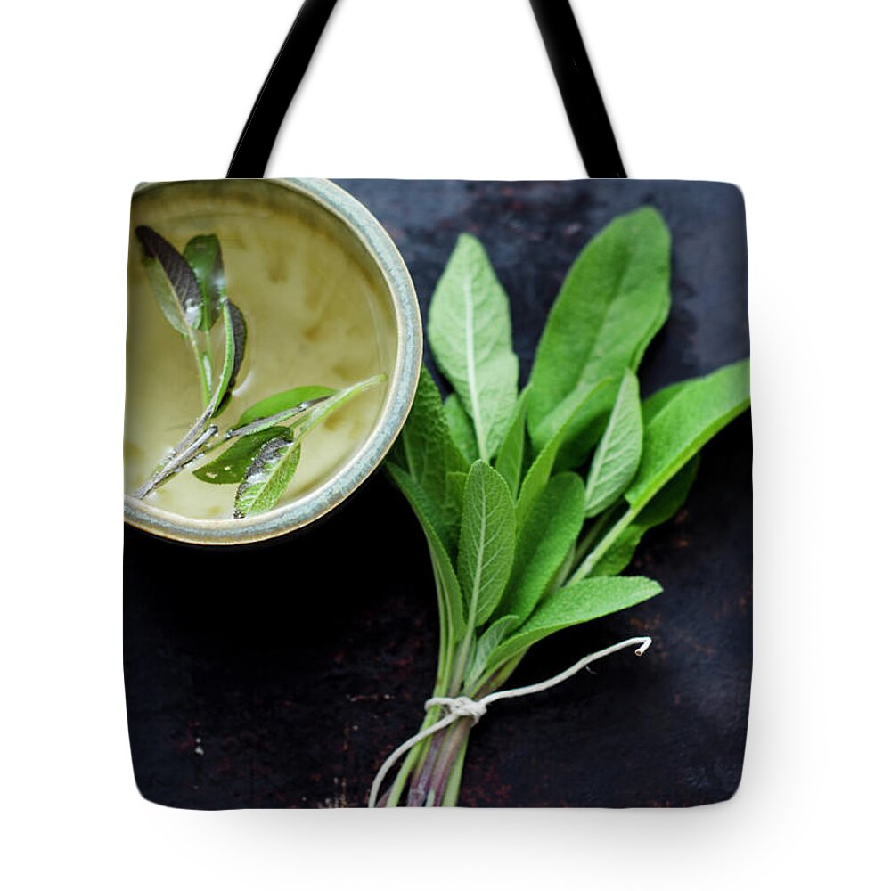 Spice Tote Bag featuring the photograph Sage Tea In Small Cup With Bunch Of by Westend61