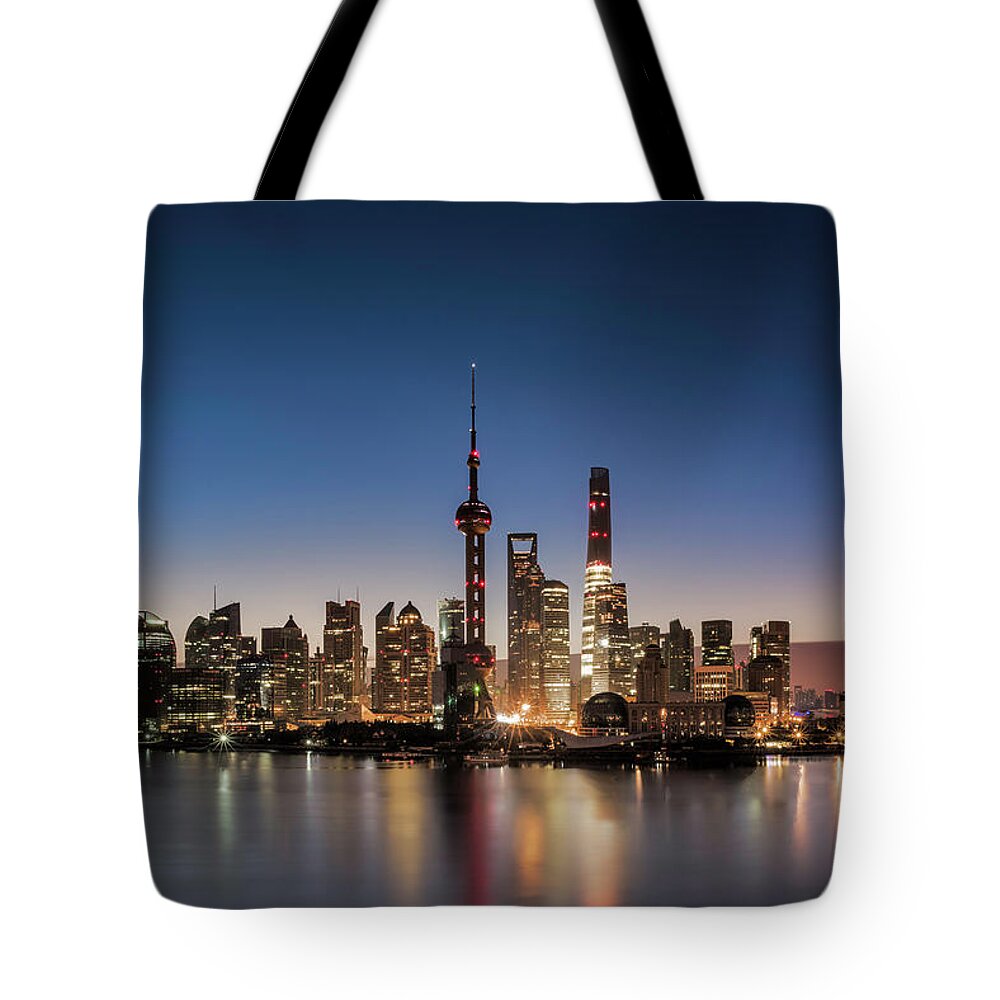 Dawn Tote Bag featuring the photograph Shanghai Skyline And Huangpu River At by Martin Puddy
