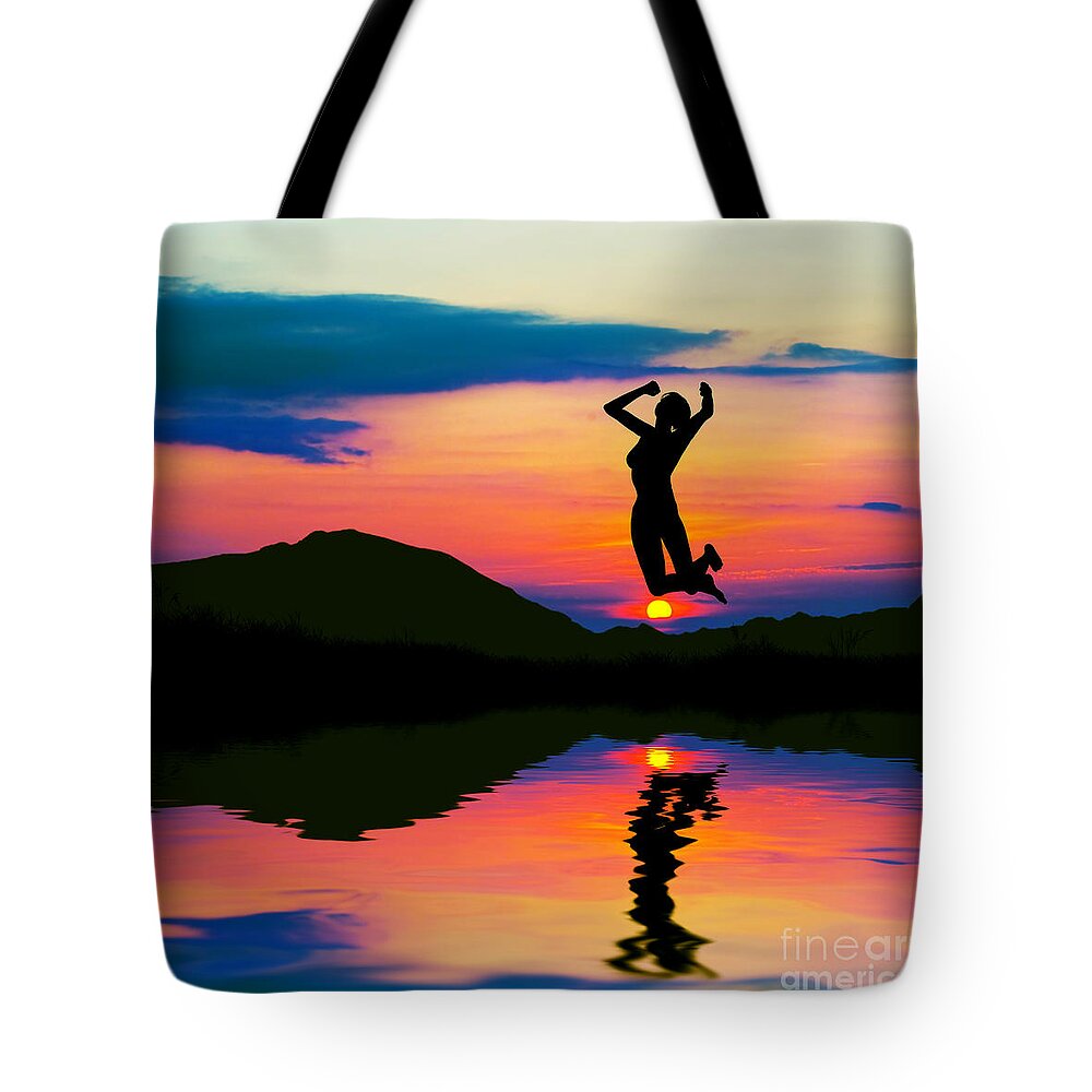 Victory Tote Bag featuring the photograph Silhouette of happy woman jumping at sunset by Michal Bednarek