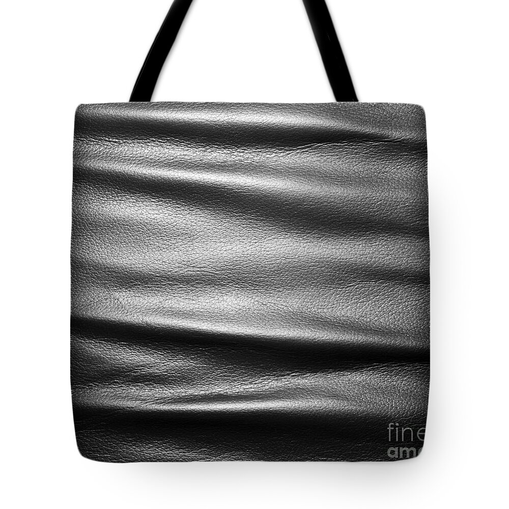 Leather Tote Bag featuring the photograph Soft wrinkled black leather by Michal Bednarek